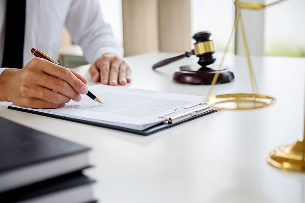 Picture of a person signing a contract